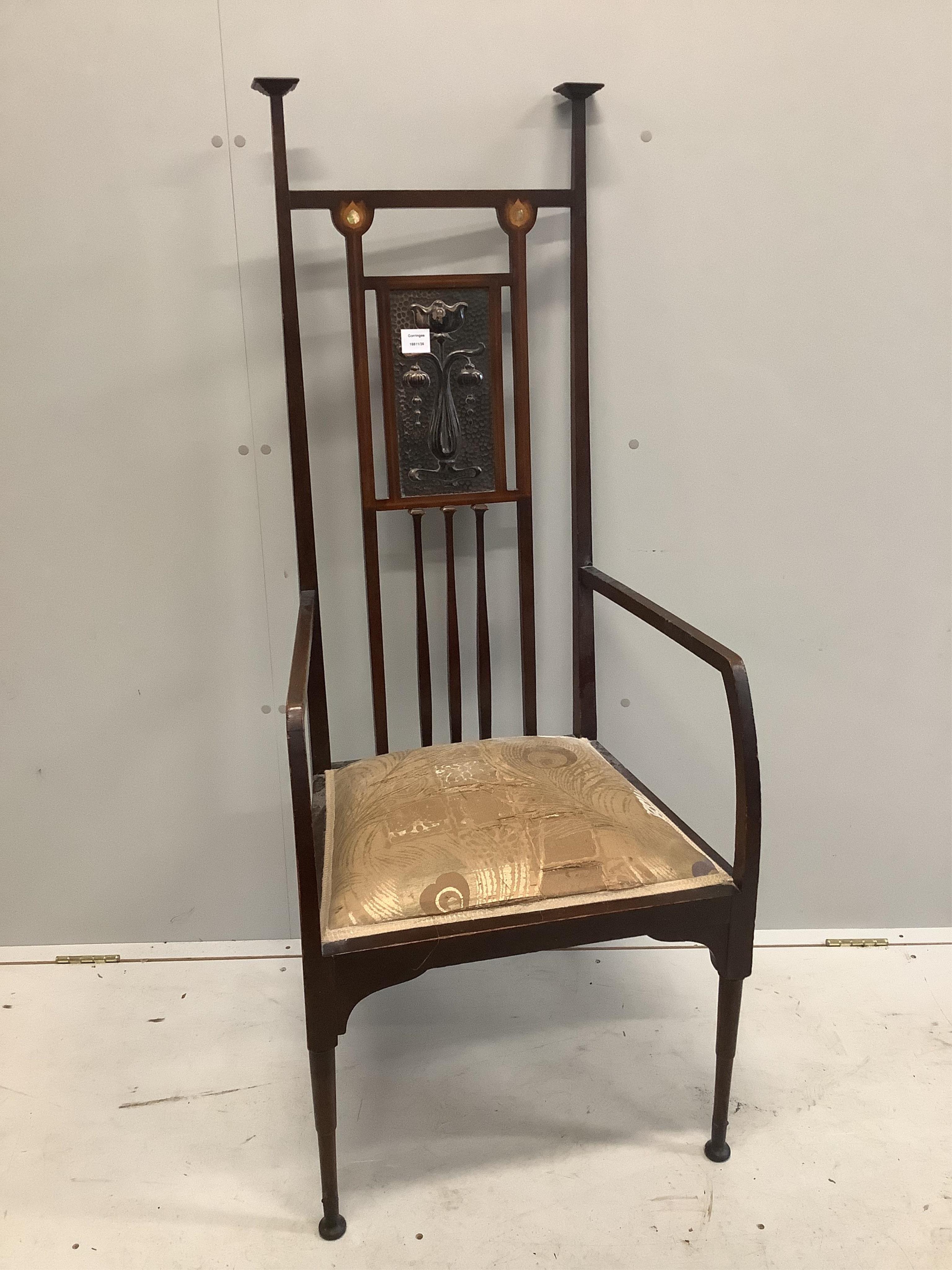 In the manner of Shapland & Petter, an Art Nouveau mahogany high backed elbow chair, the back inset with an embossed copper plaque, width 56cm, depth 48cm, height 138cm. Condition - fair